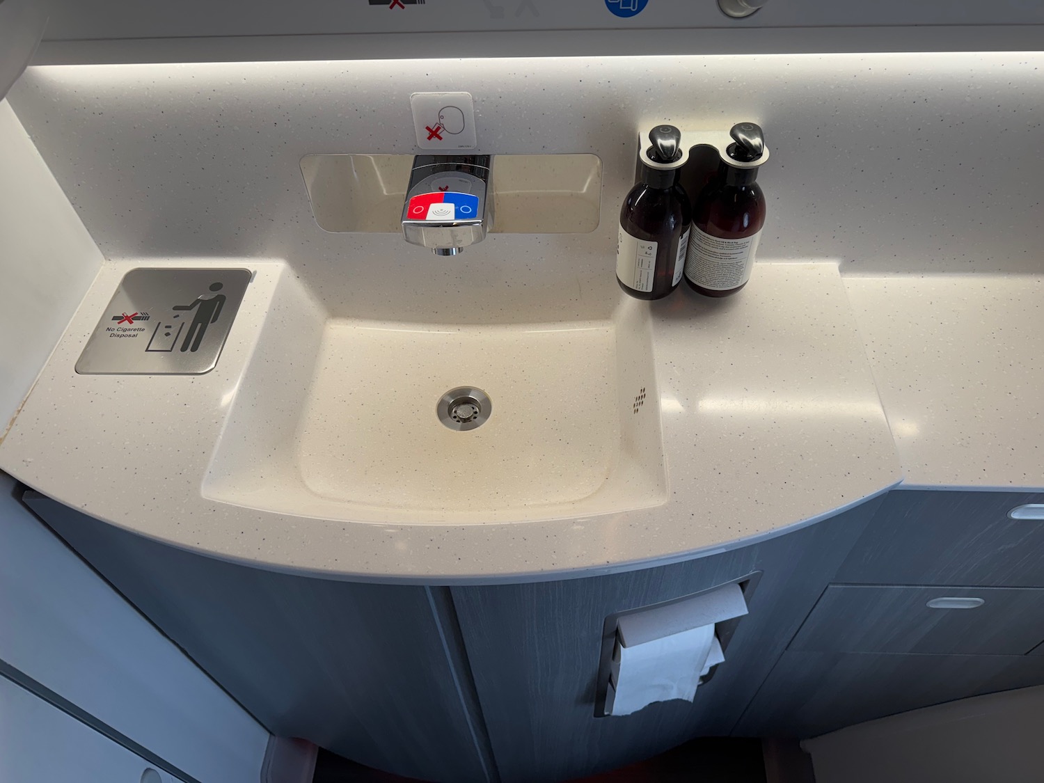 a sink with soap and bottles on it
