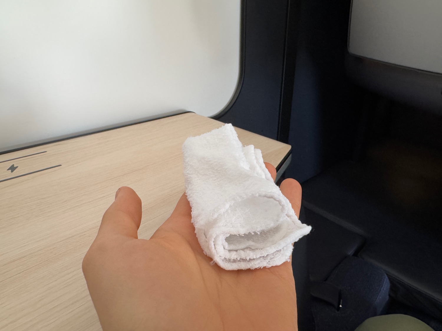 a hand holding a white towel