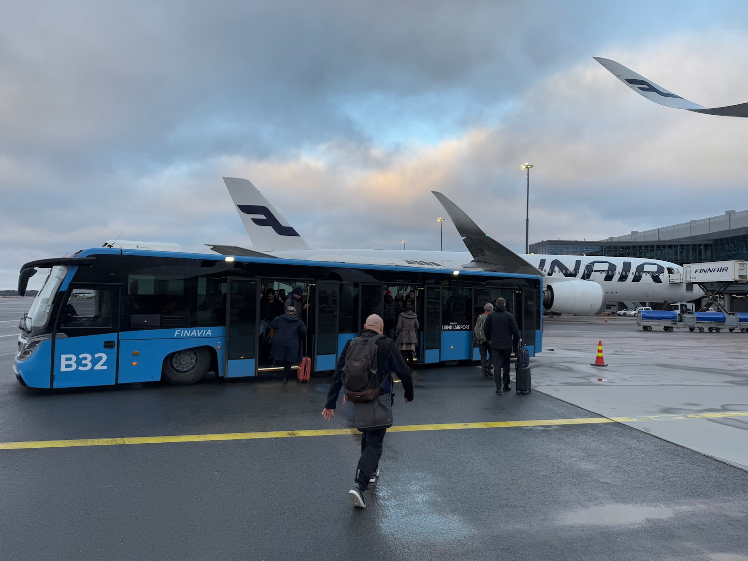 a group of people boarding a bus