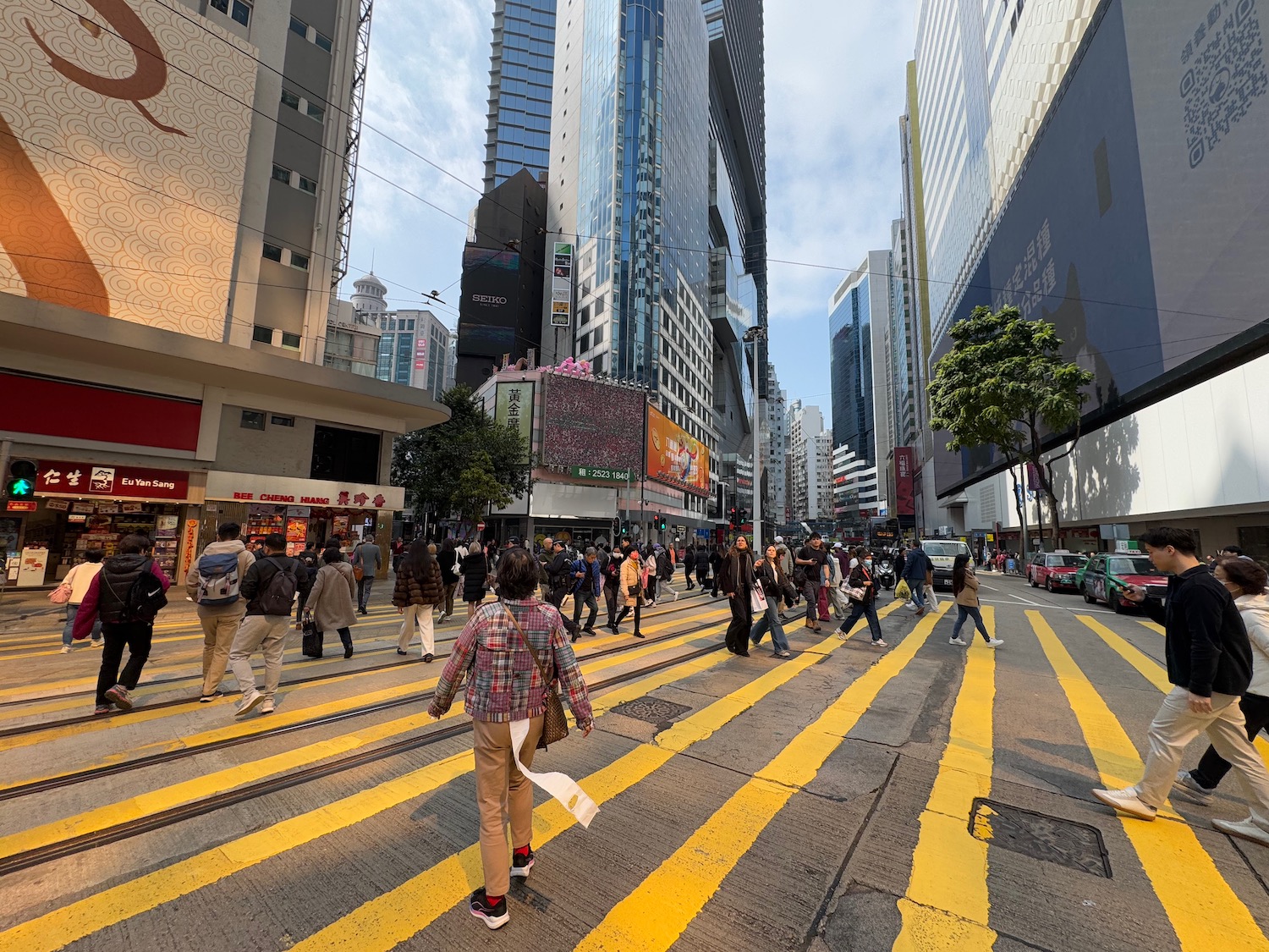 a group of people crossing a street in a city