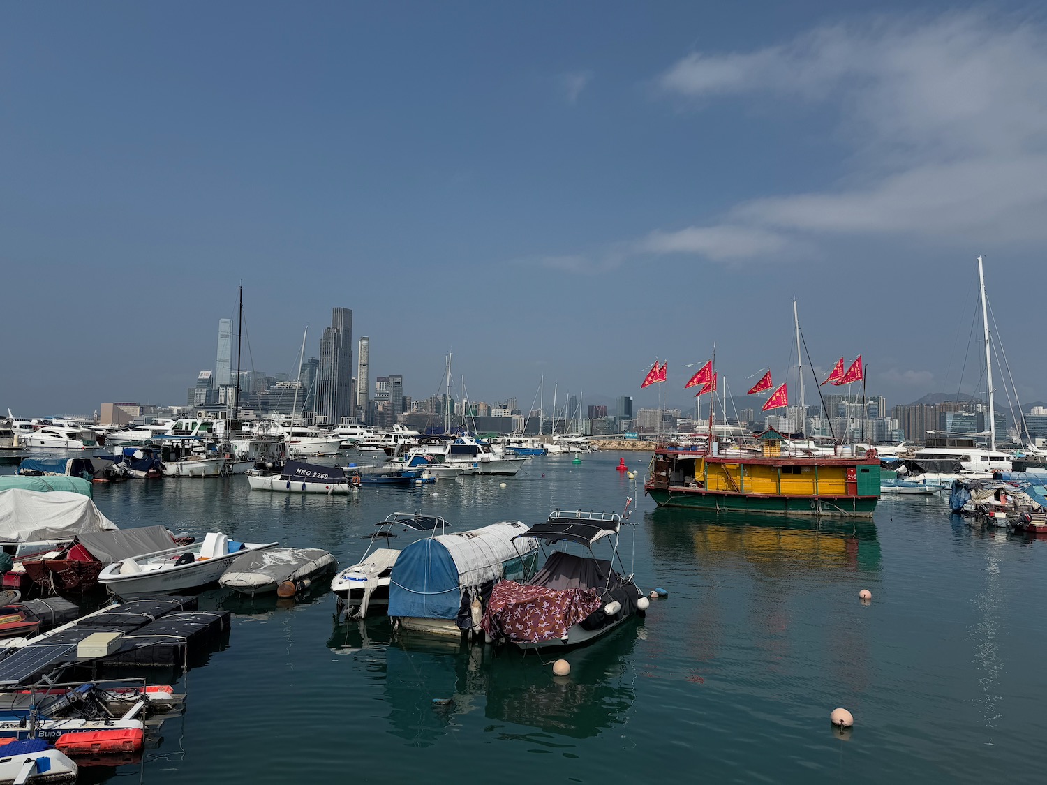 boats in a harbor with boats and a city in the background