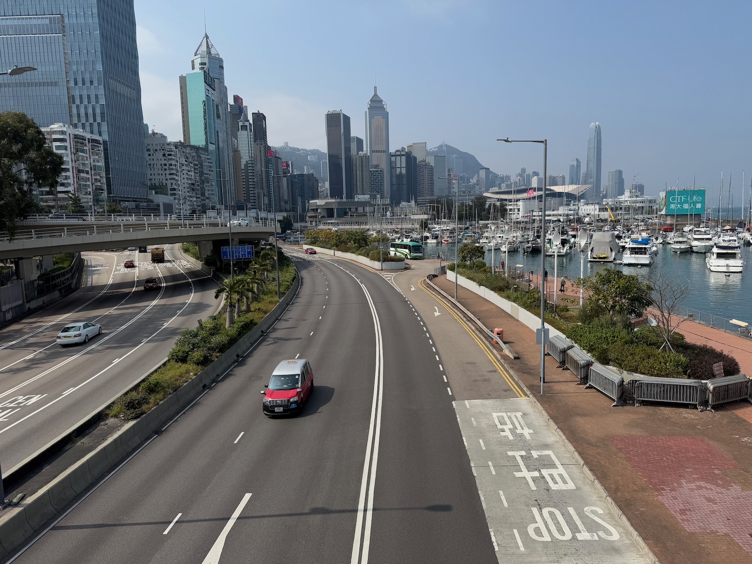 a road with cars and a city in the background
