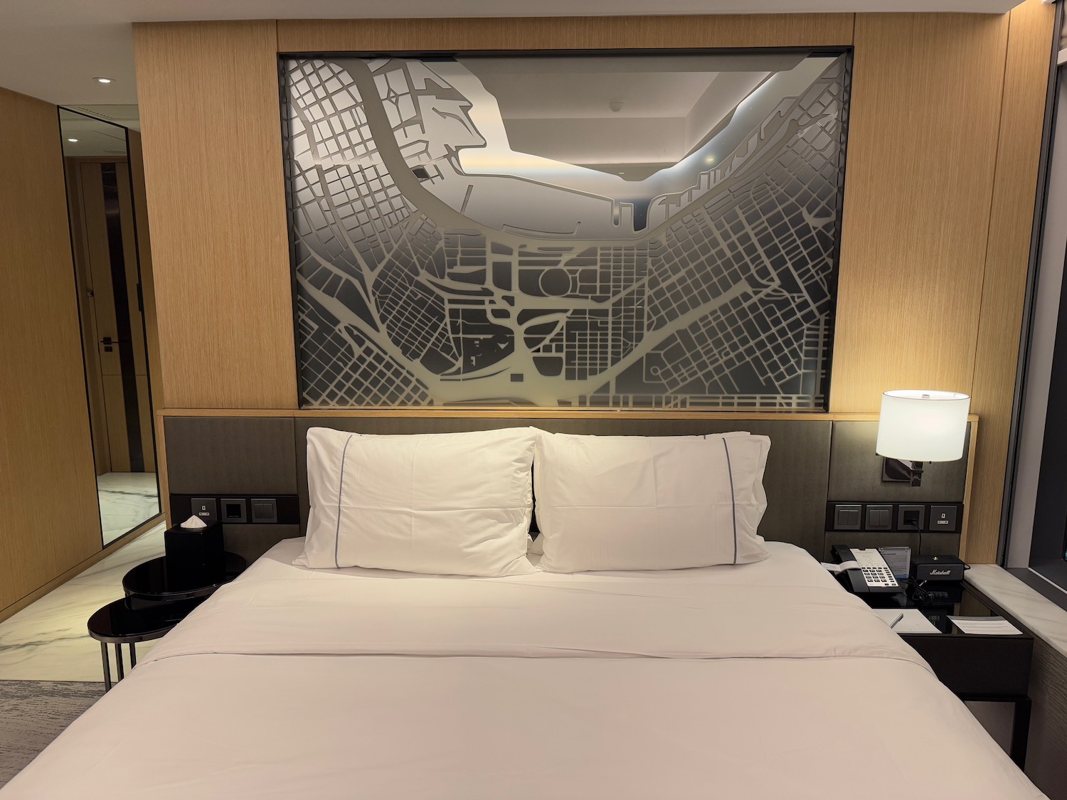 a bed with a map above it
