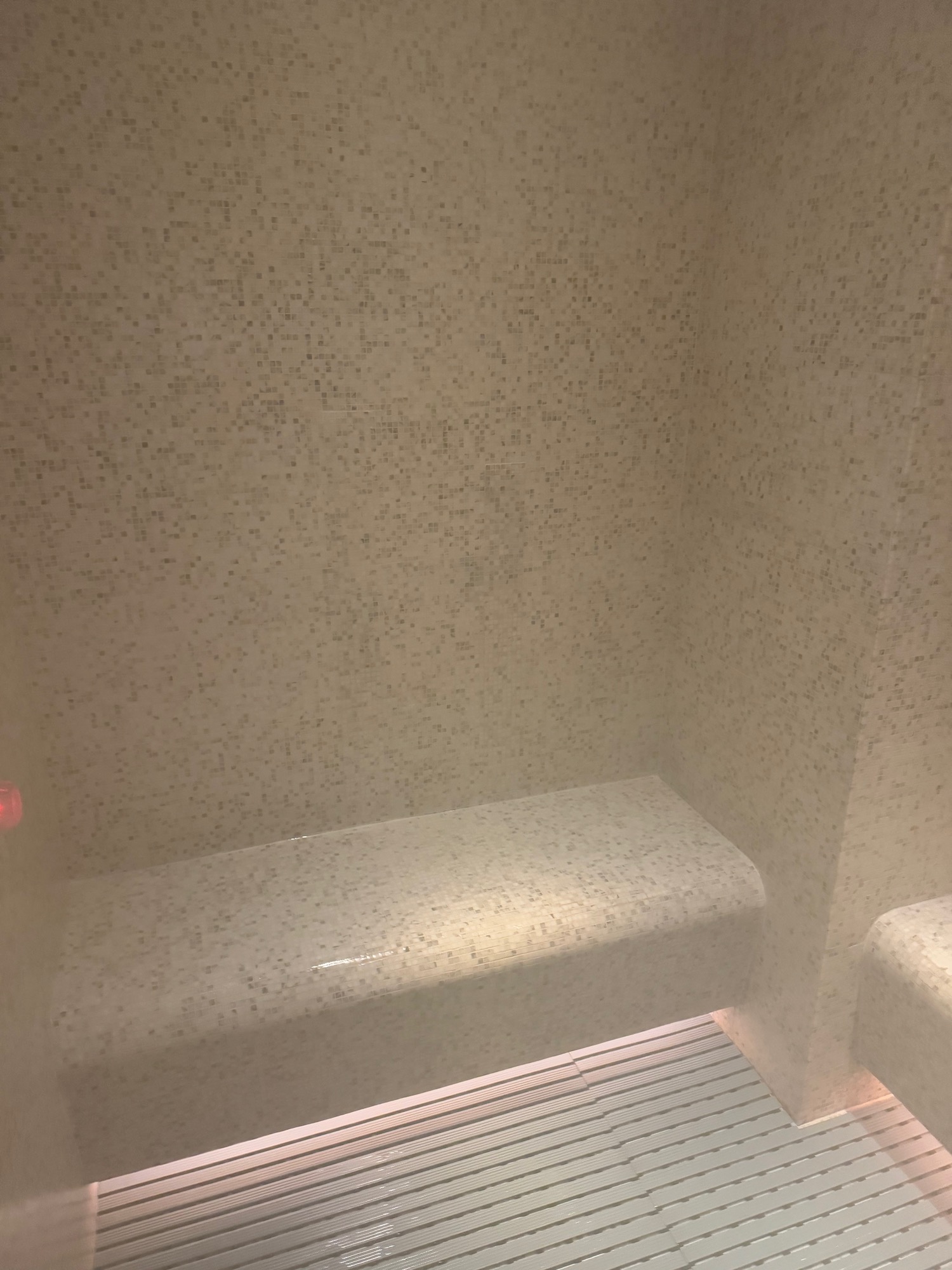 a tiled wall with a bench