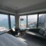 a room with a large window overlooking a body of water