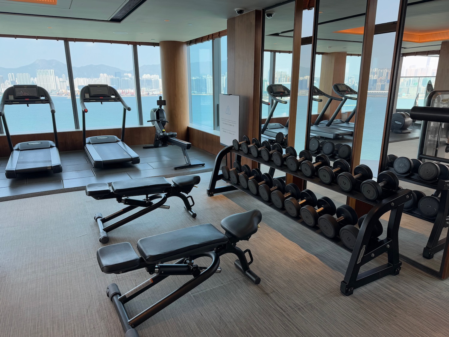 a room with exercise equipment and a large window