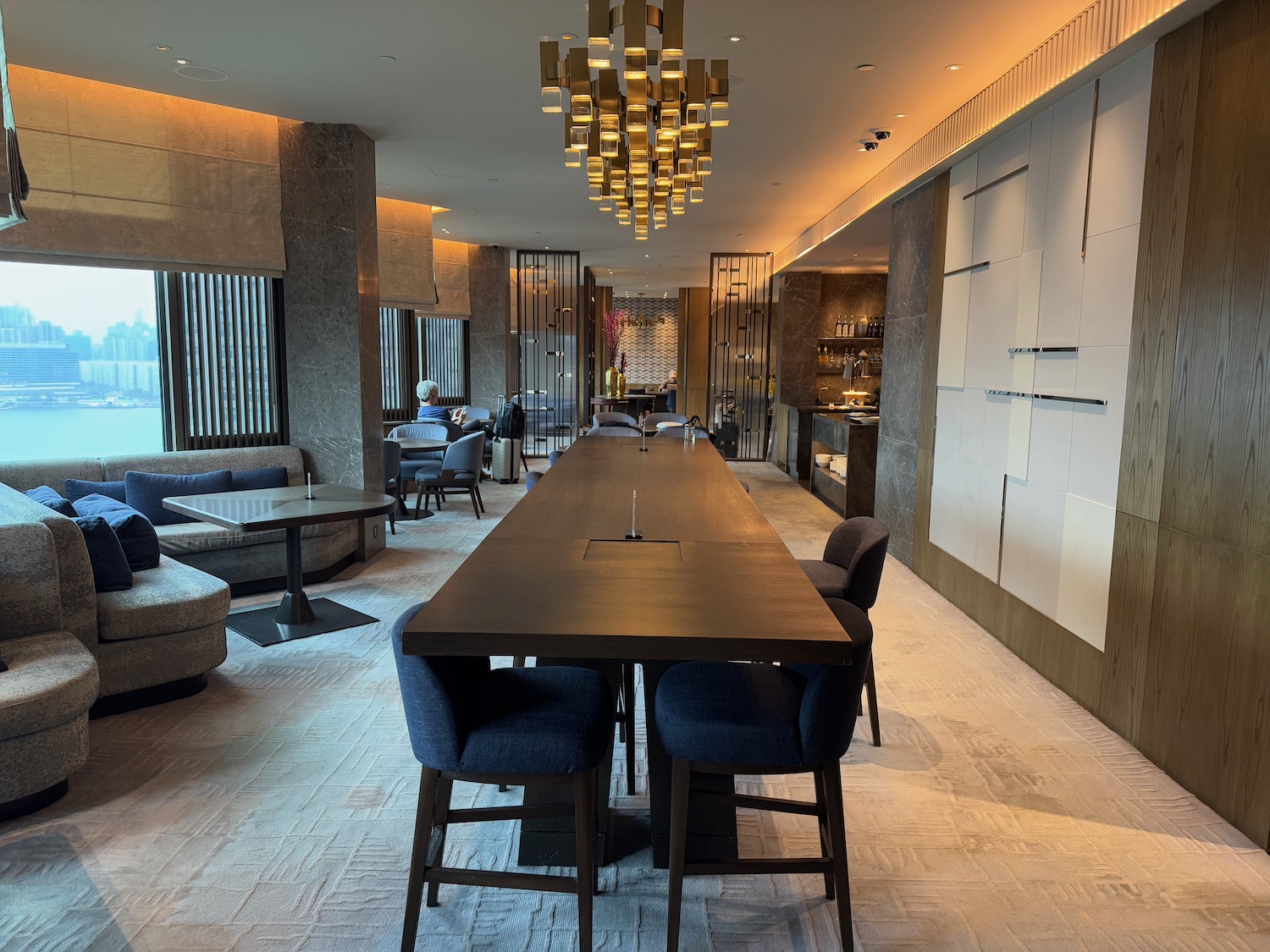 a long table in a room with chairs and a chandelier