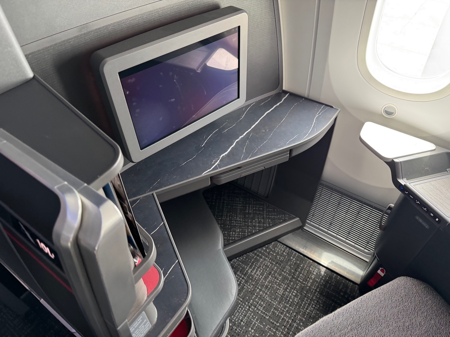 a desk and a monitor in an airplane