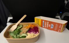 a bowl of food with a fork and a wooden spoon