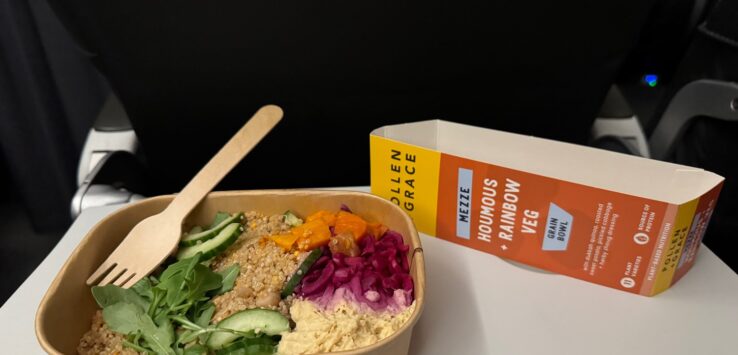 a bowl of food with a fork and a wooden spoon