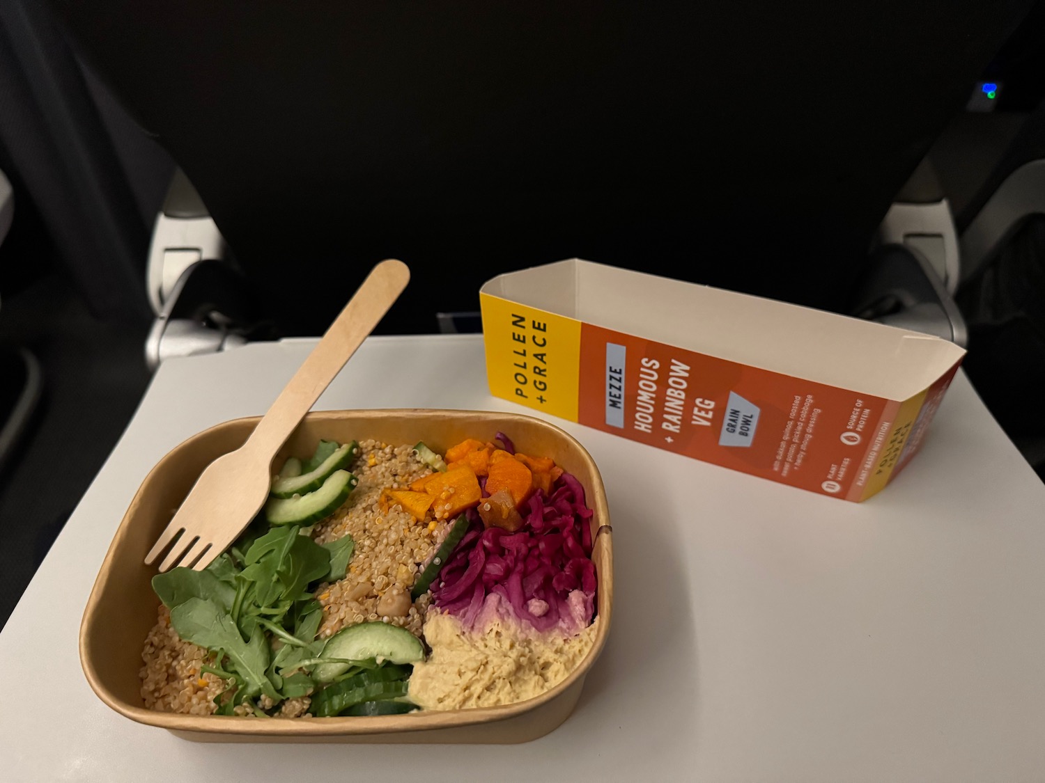a bowl of food with a fork and a box of food