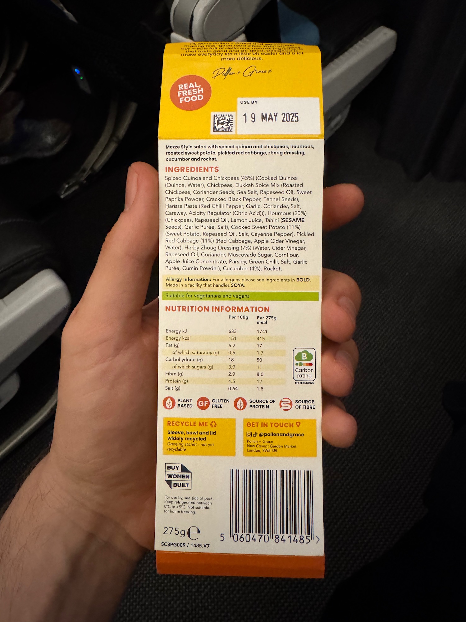 a hand holding a carton of food