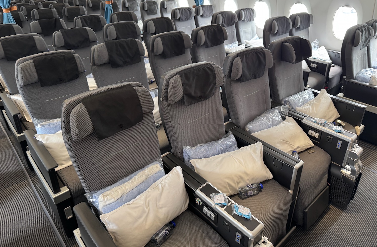 a row of seats with pillows