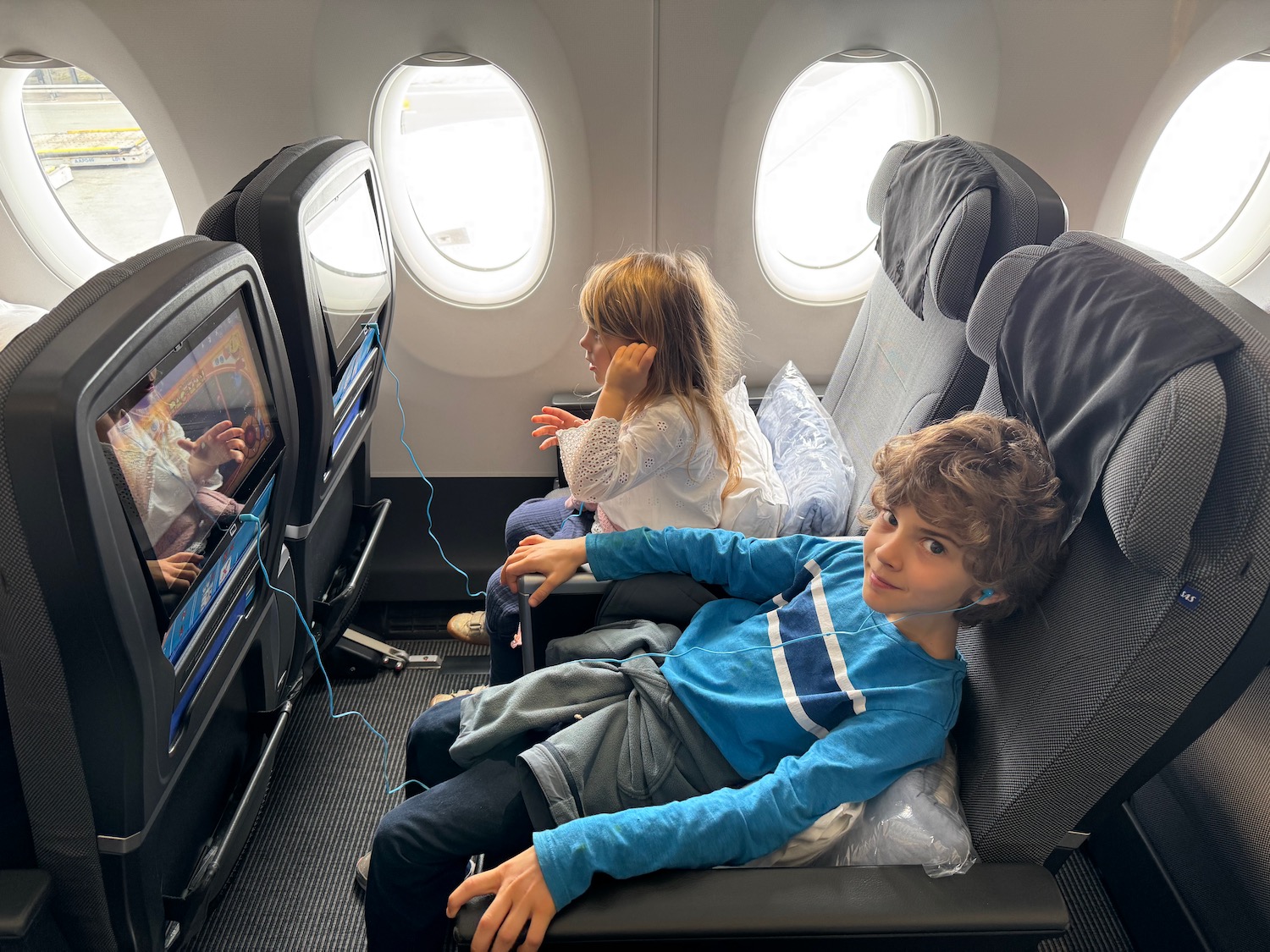 a group of kids sitting in an airplane