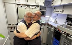 two men hugging in a room