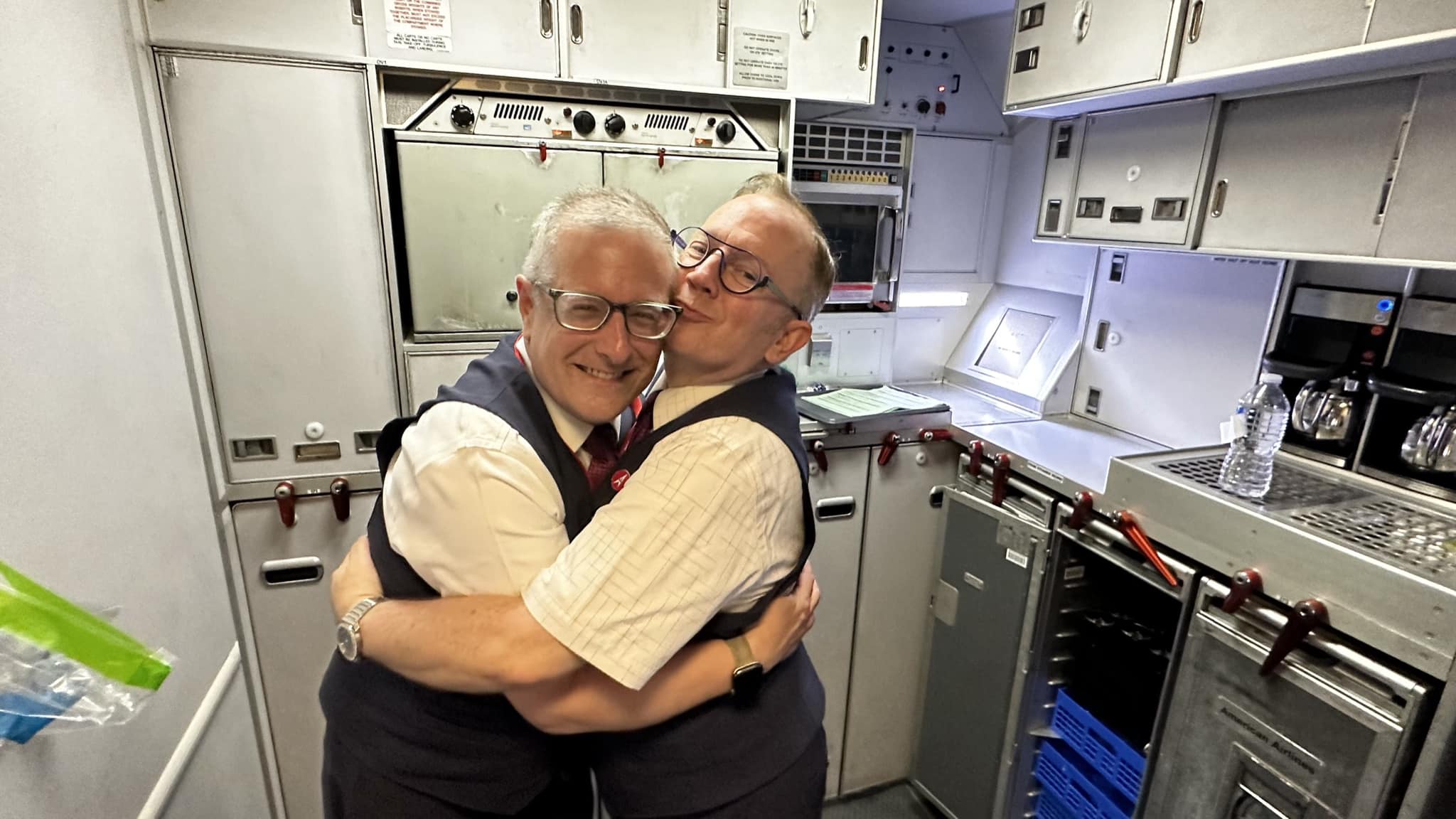 two men hugging in a room