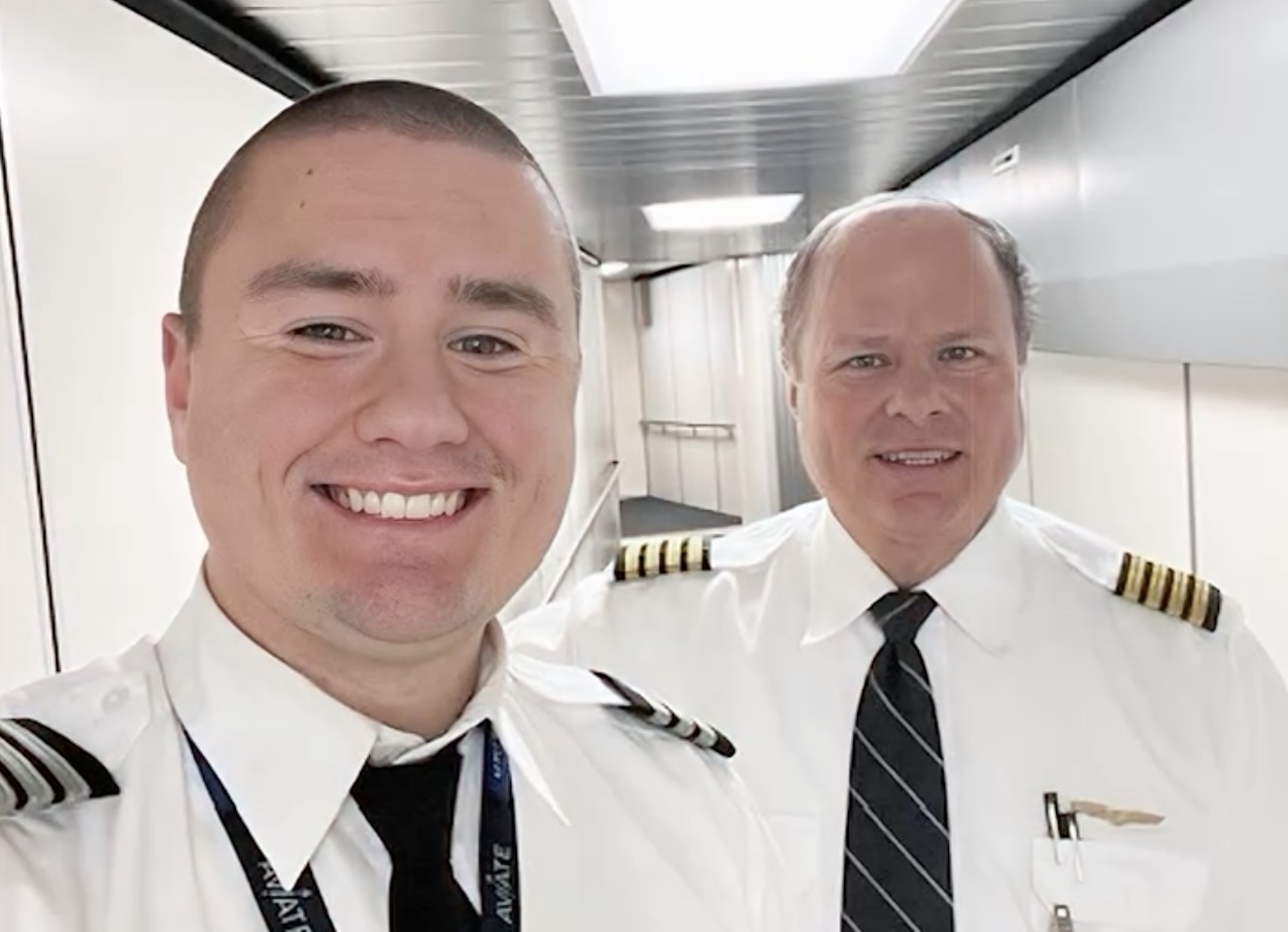 two men in uniform smiling