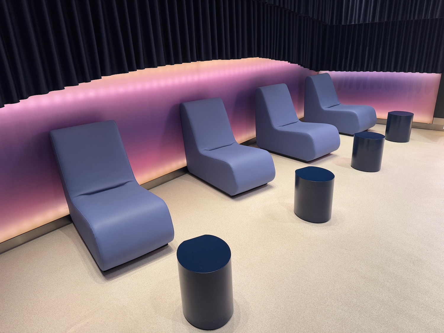 chairs in a room with a pink and purple wall