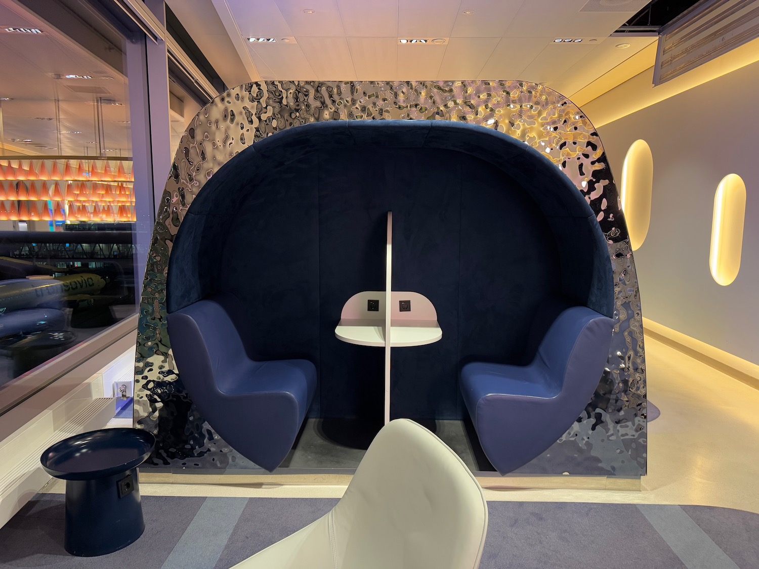 a room with a round table and chairs