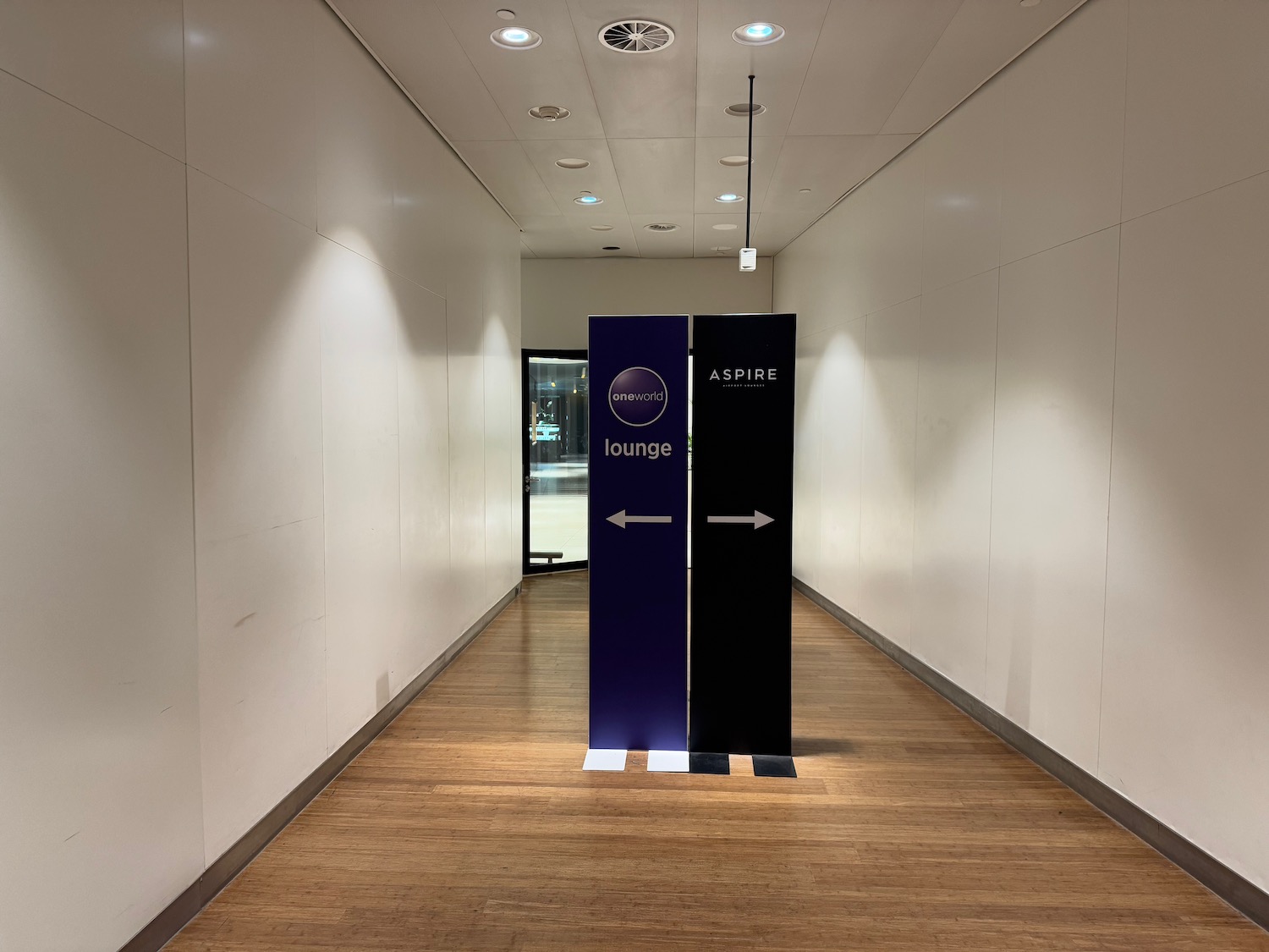 a long hallway with signs and a door