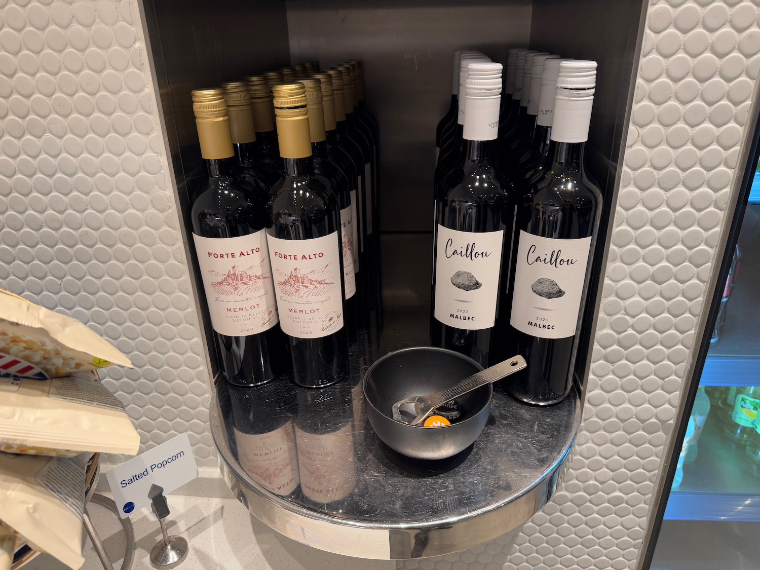 a shelf with bottles of wine