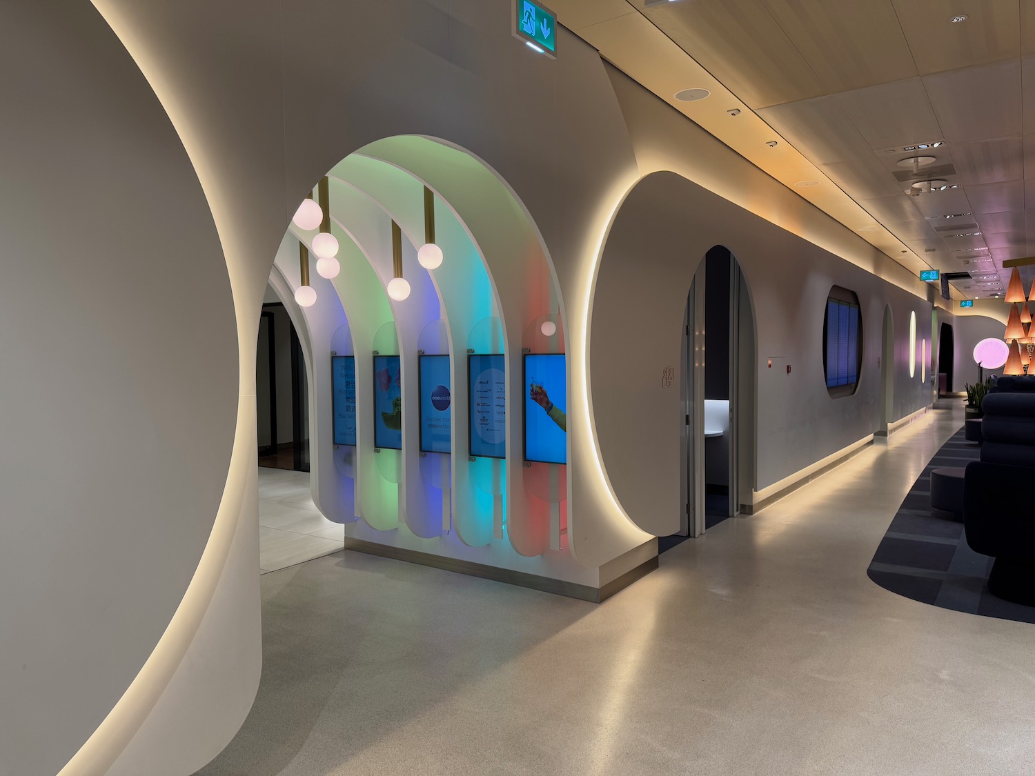 a hallway with a wall with lights and a television screen