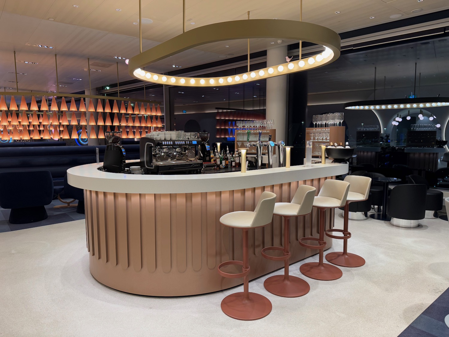 a bar with chairs and a light fixture