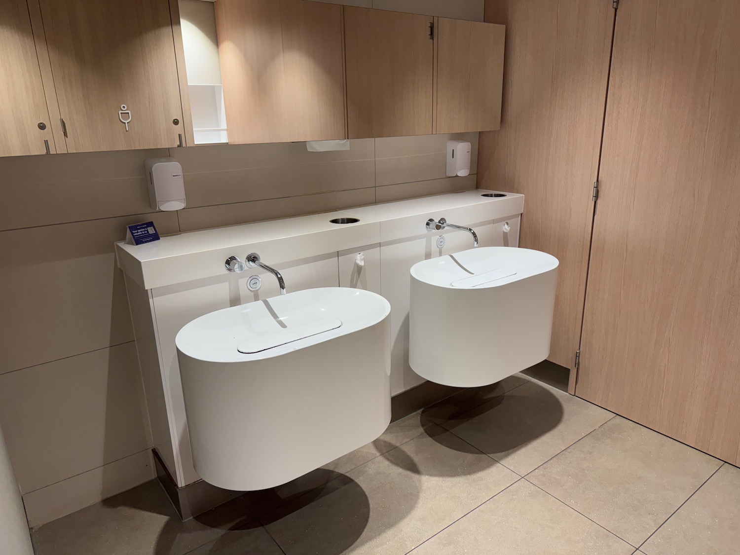 a bathroom with sinks and cabinets