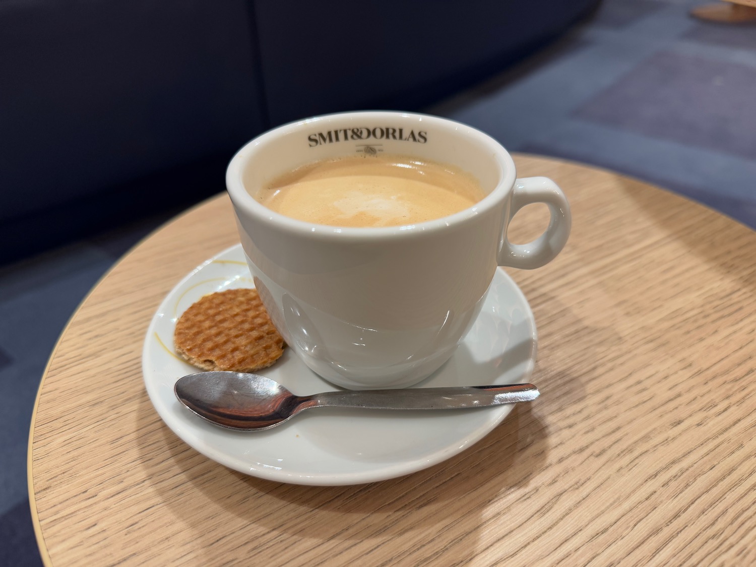 a cup of coffee and a spoon on a saucer