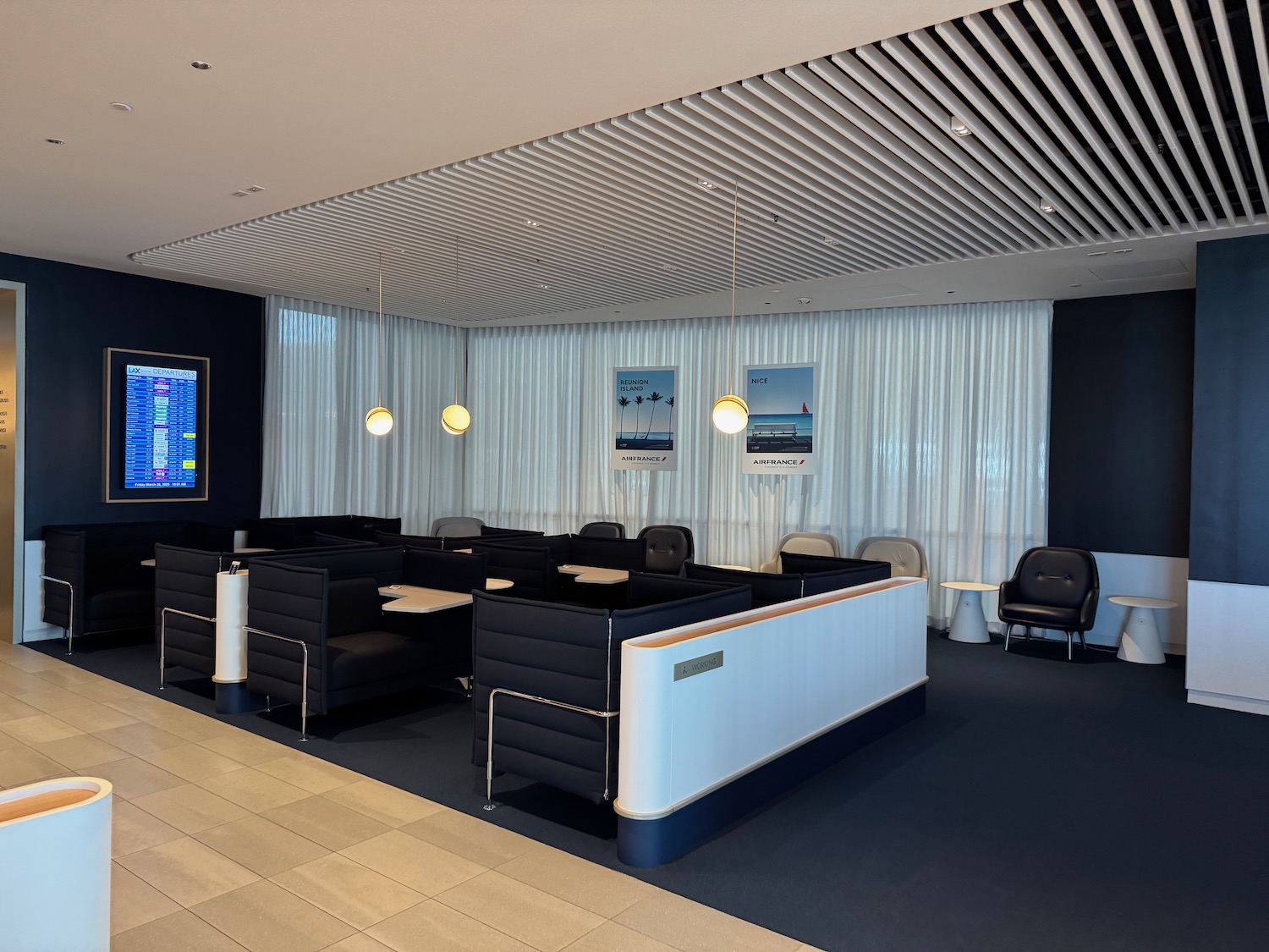 a room with black chairs and a tv