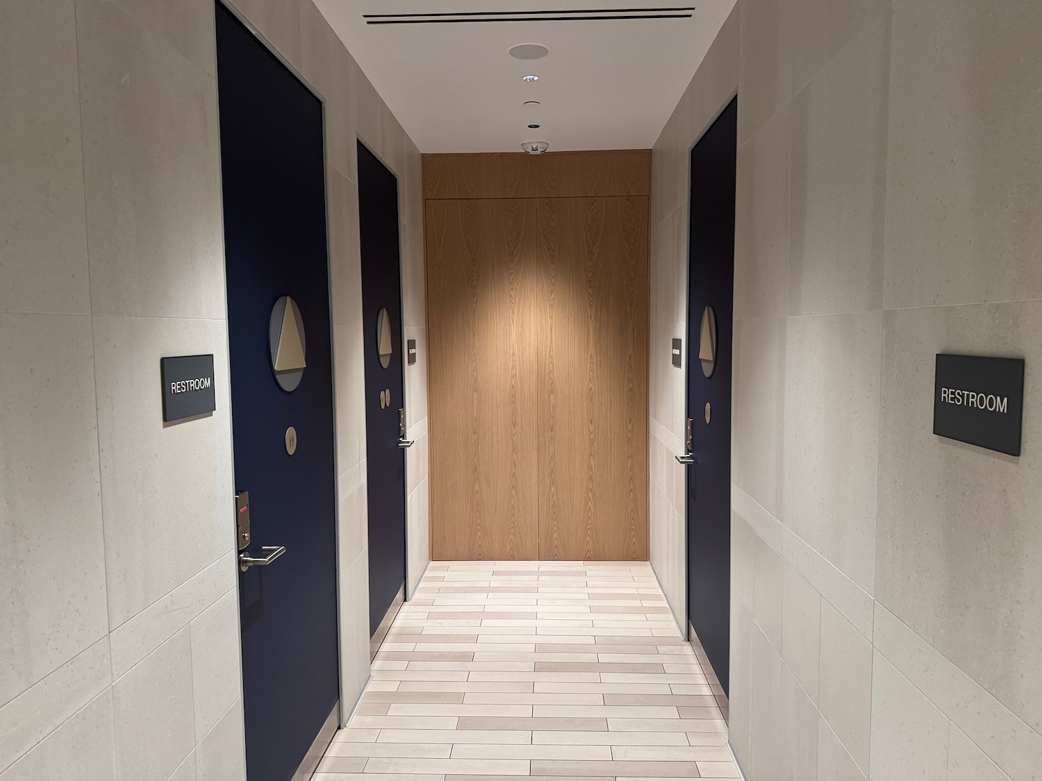 a hallway with blue doors and wood floors