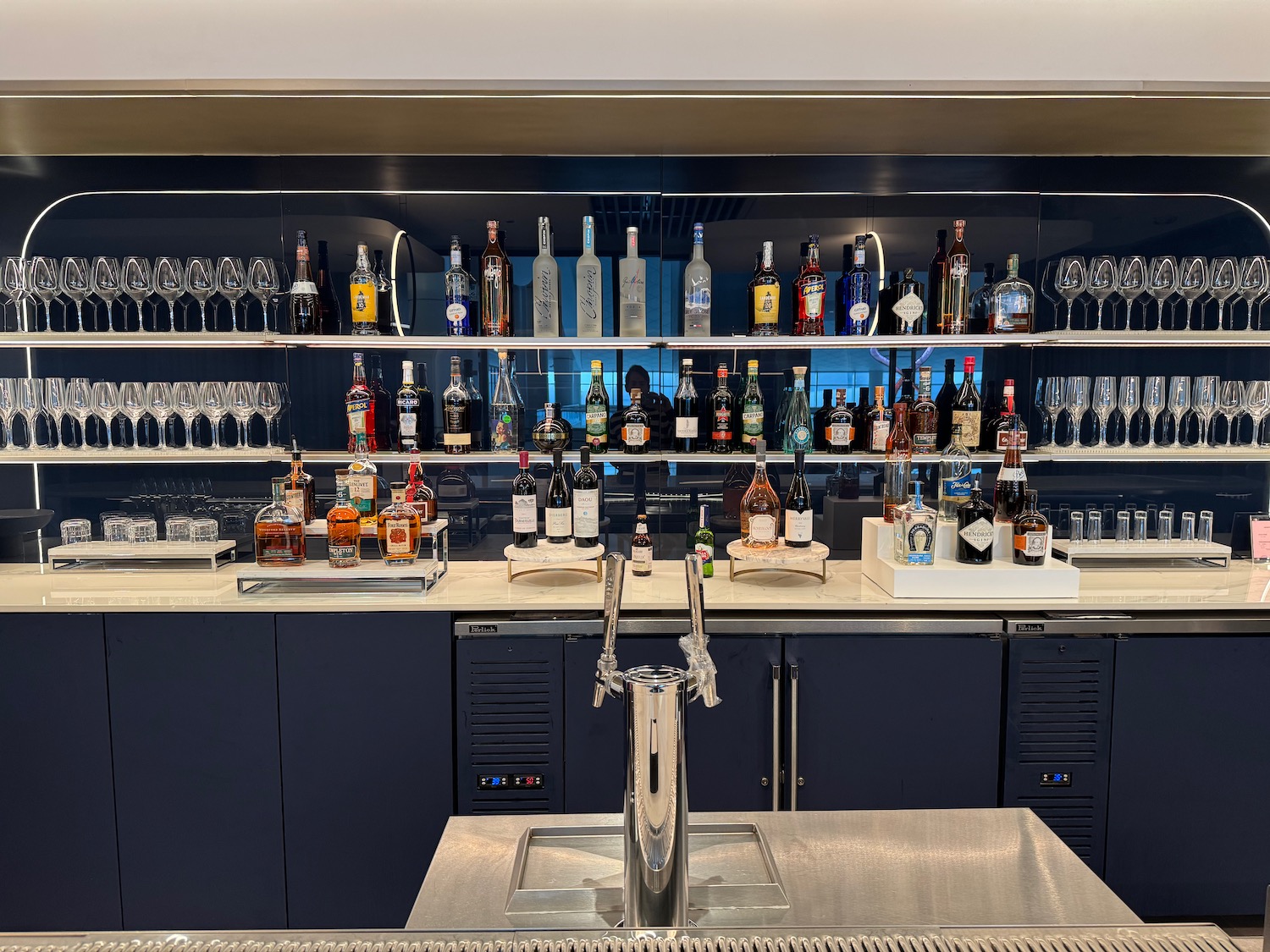 a bar with bottles of alcohol and glasses
