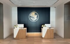 a room with white and black walls and a black wall with a logo on the wall