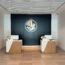 a room with white and black walls and a black wall with a logo on the wall