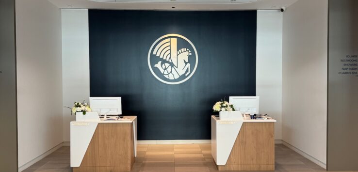 a room with white and black walls and a black wall with a logo on the wall