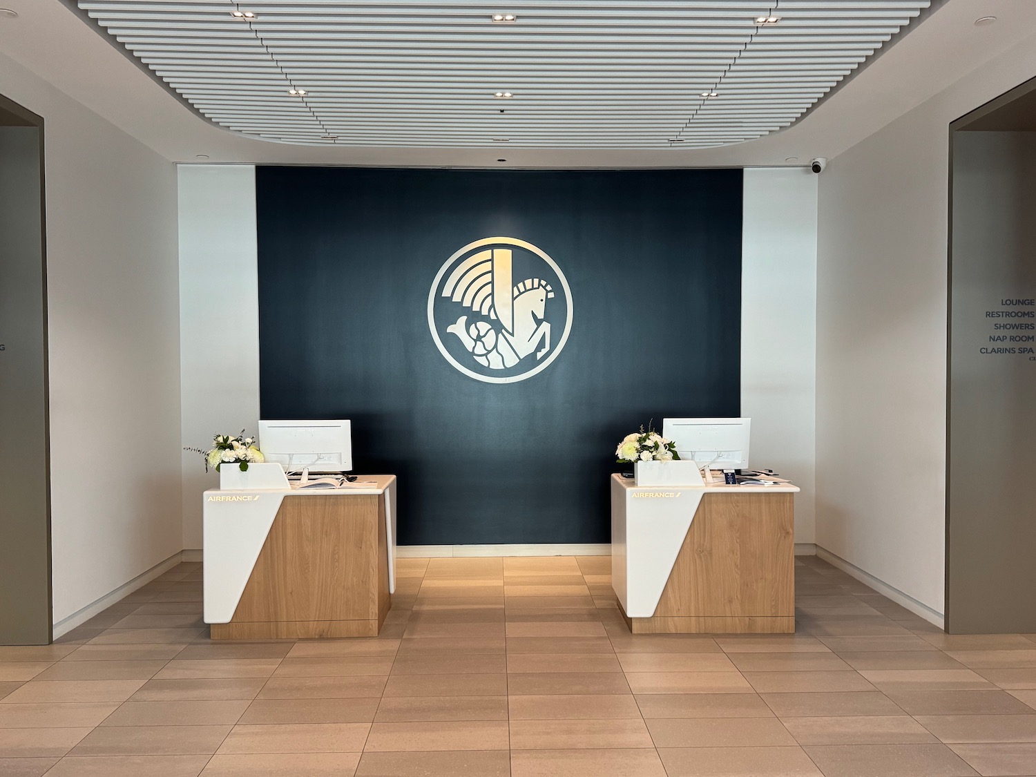 a room with white and black walls and a black wall with a logo on the wall