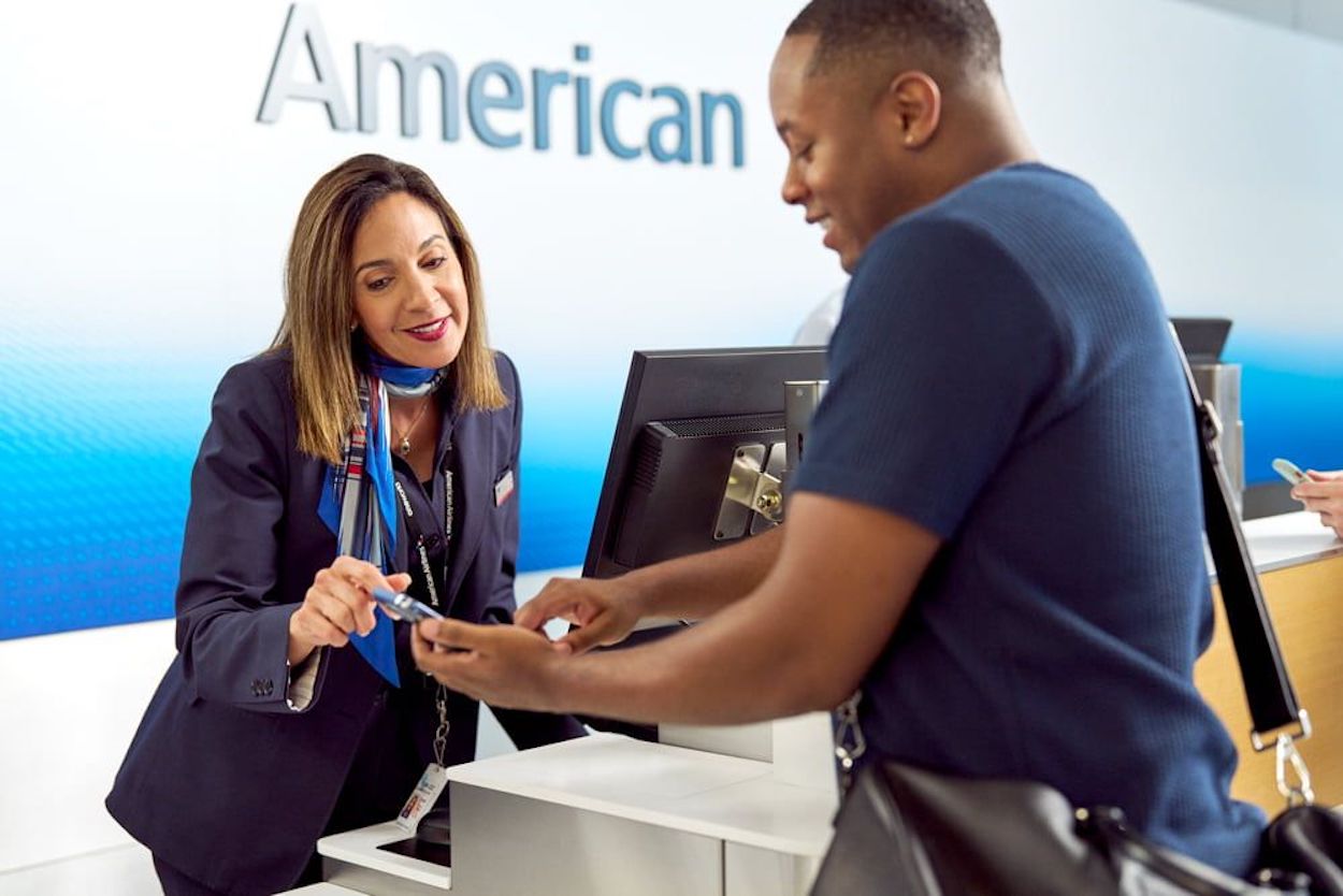 a woman handing a card to a man