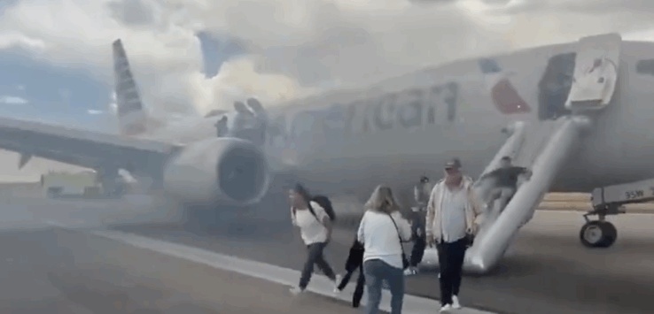 people walking on a runway with a plane in the background