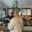 a woman standing at a counter in a coffee shop