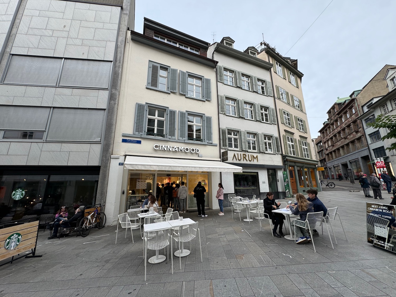 a group of people sitting outside a restaurant