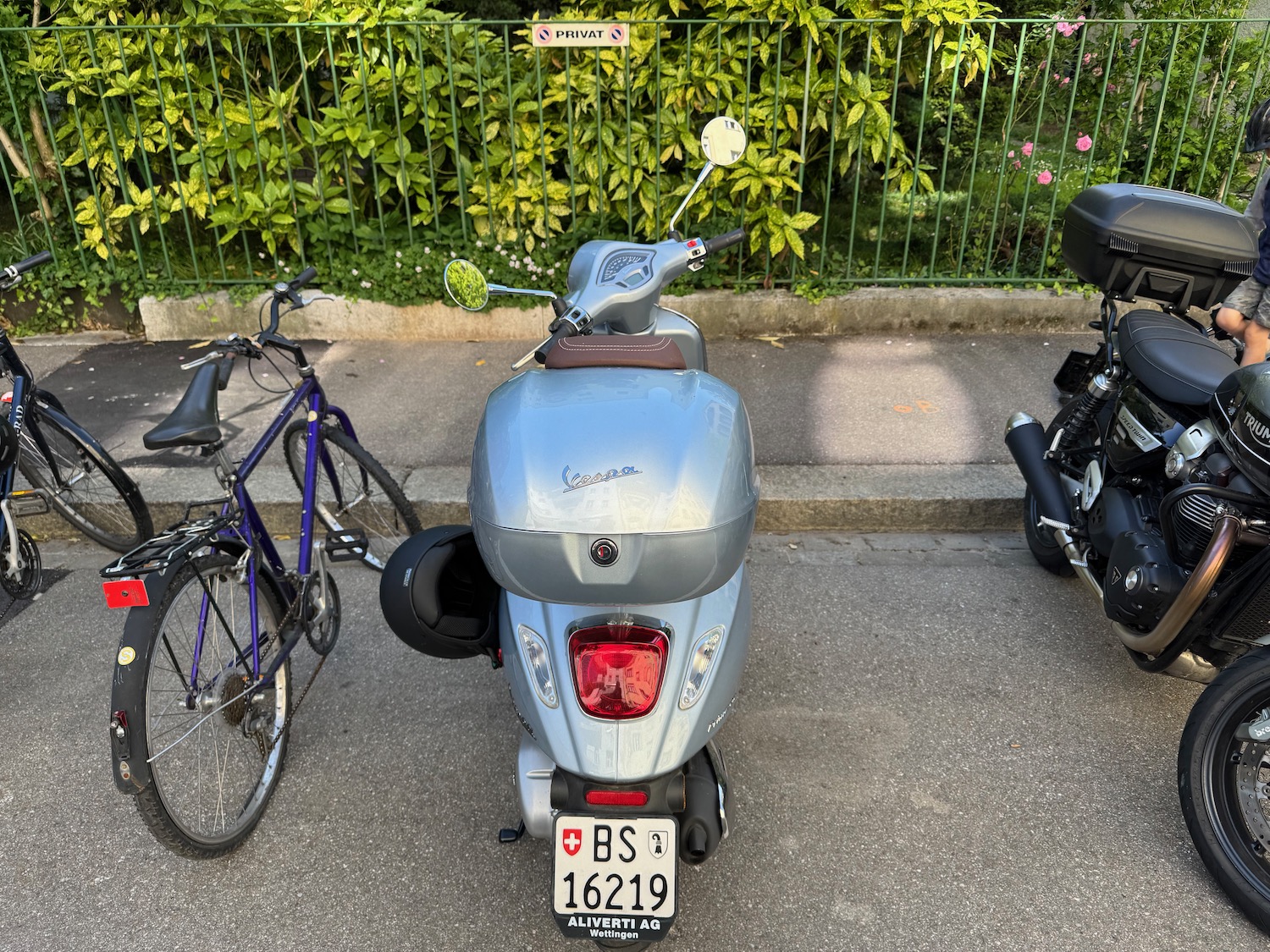 a scooter parked next to a bicycle
