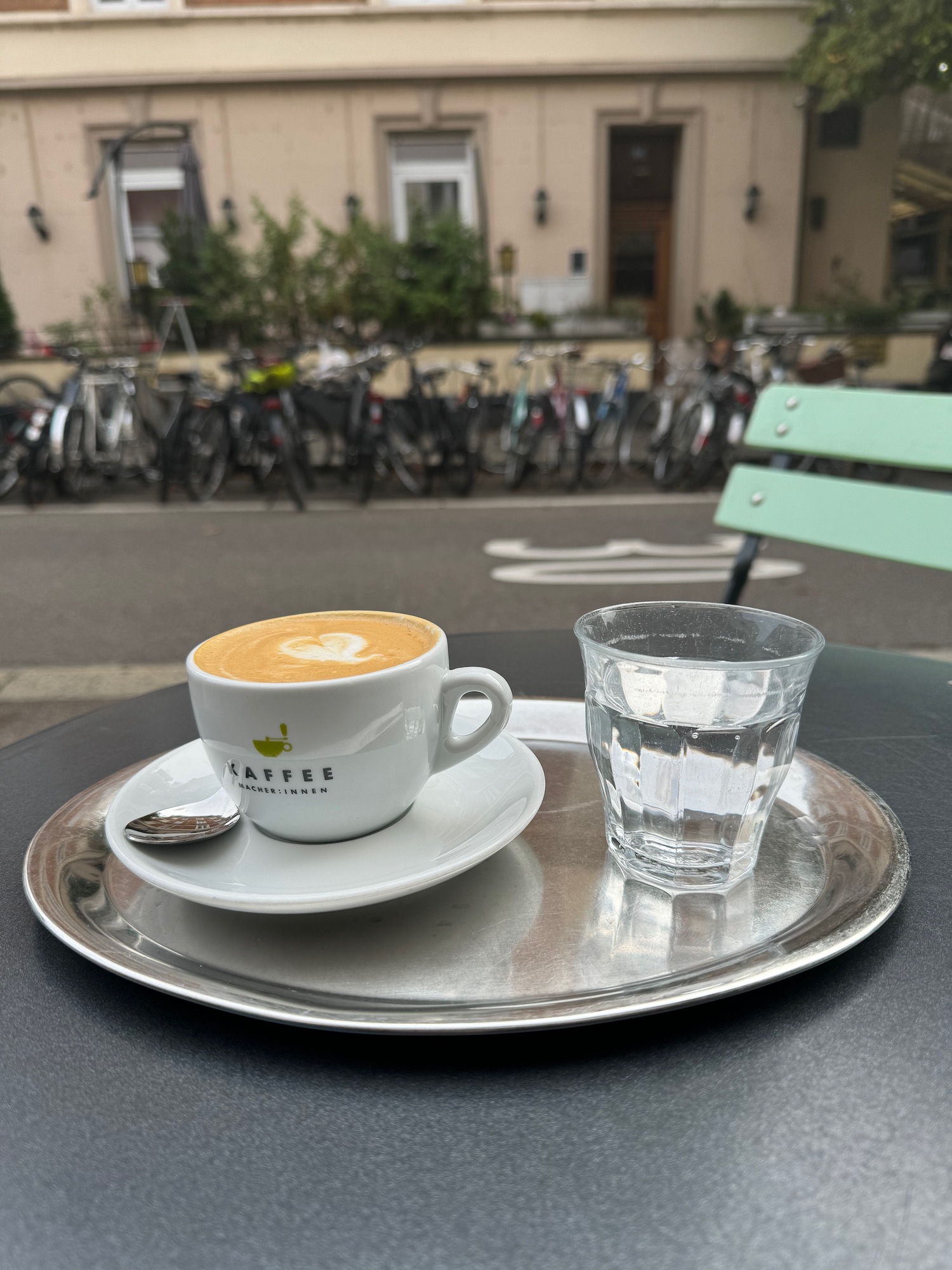 a cup of coffee and a glass of water on a table