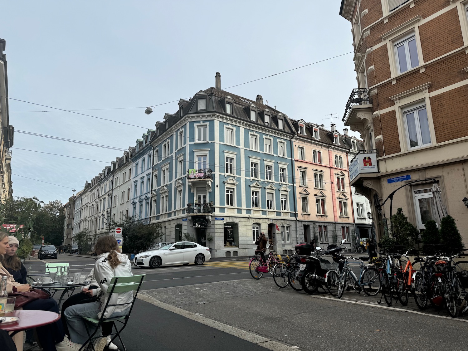 a group of people sitting on a chair in front of a row of bicycles