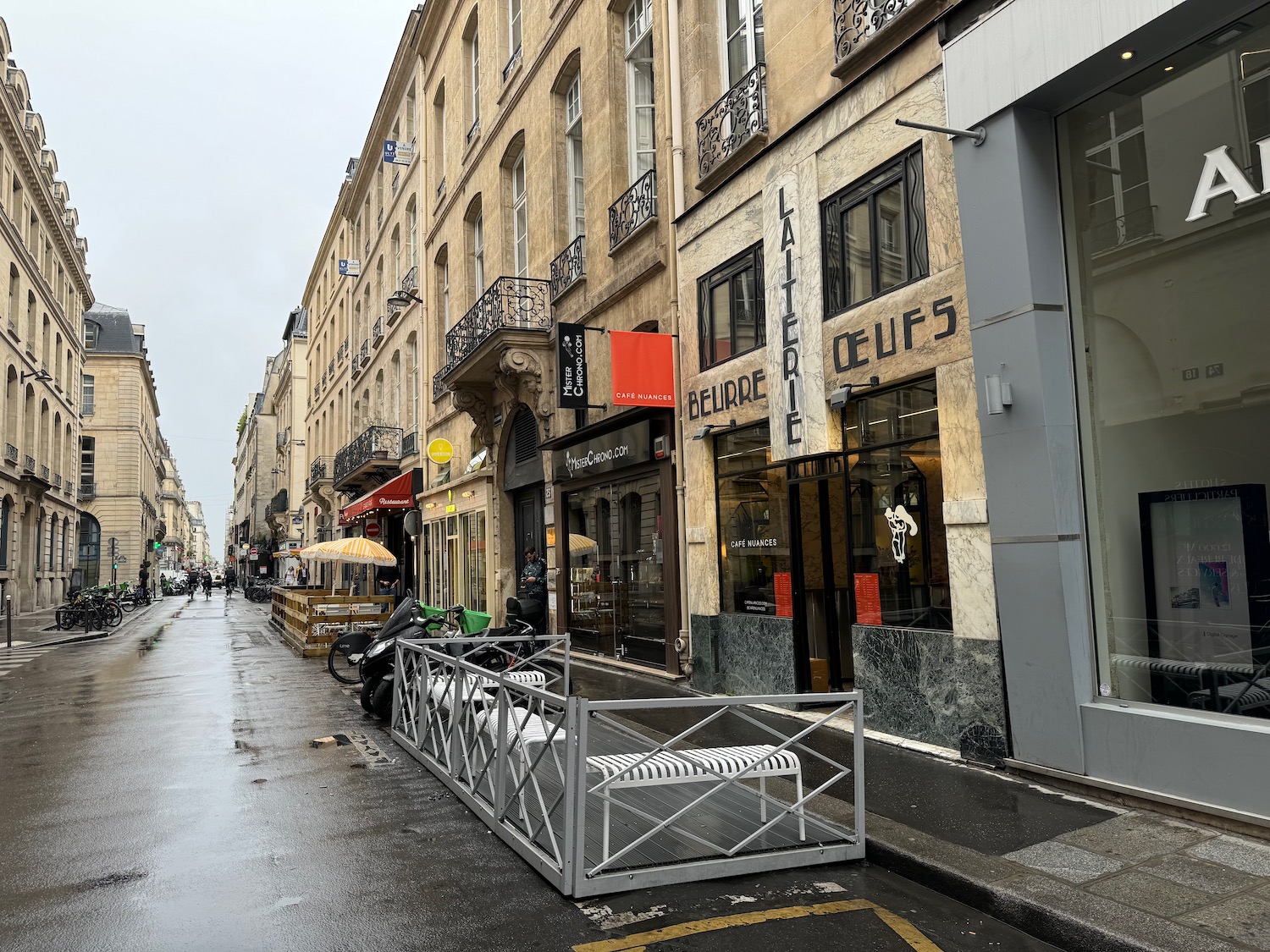 a street with buildings and a fence