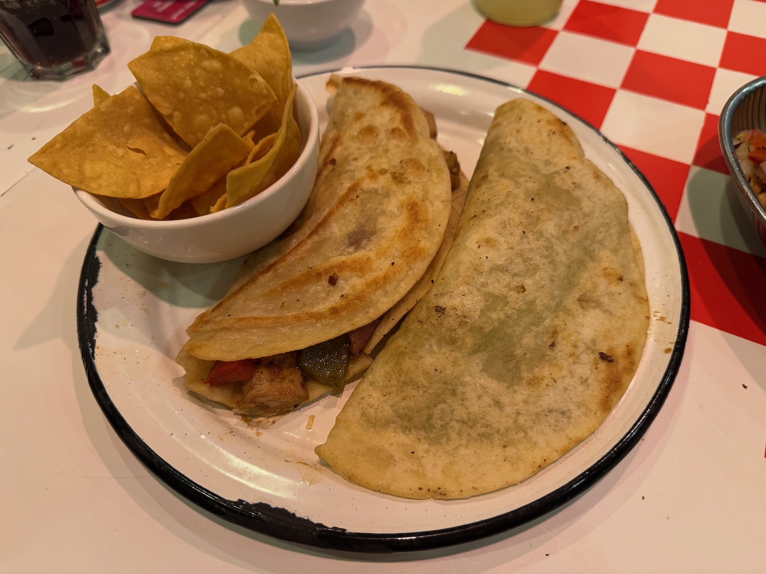 a plate of food with a bowl of chips