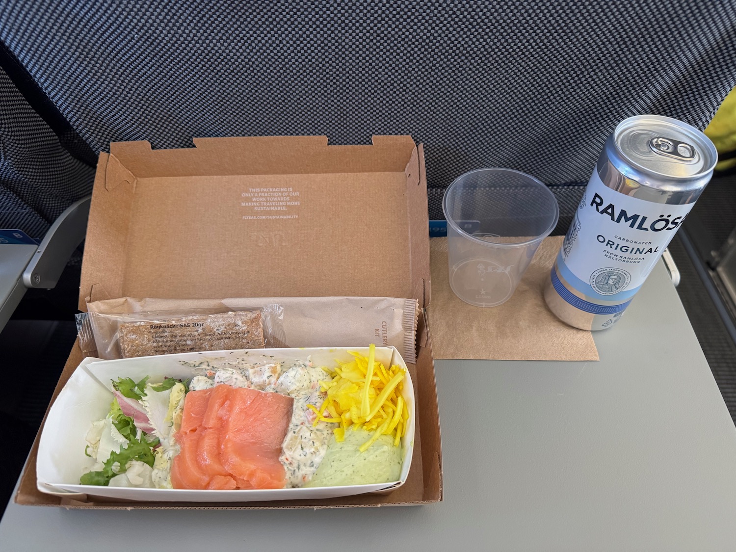 a food in a box next to a can