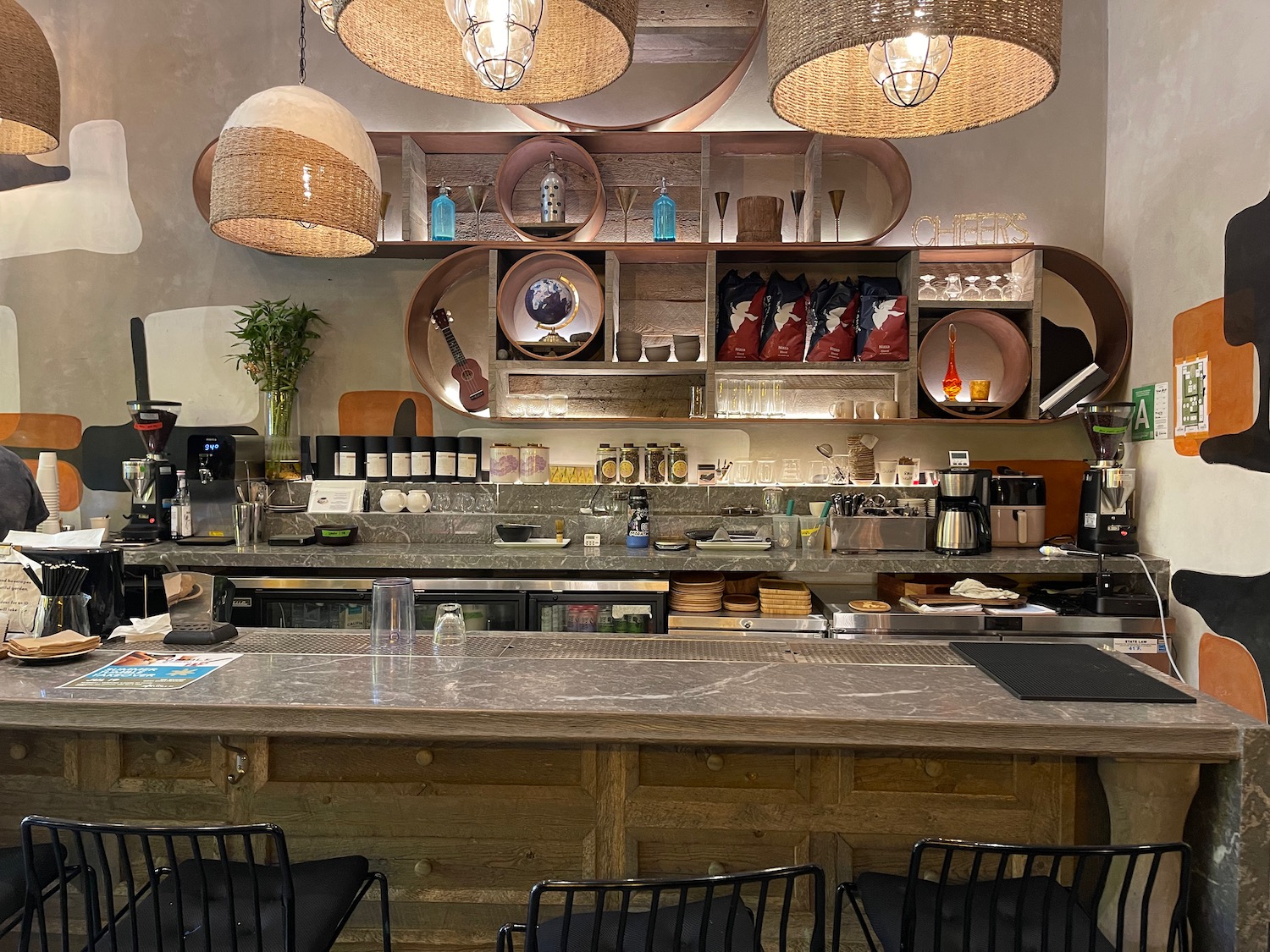a counter with a bar and chairs