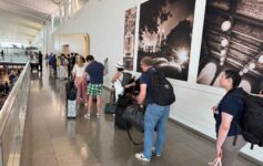a group of people standing in a line with luggage