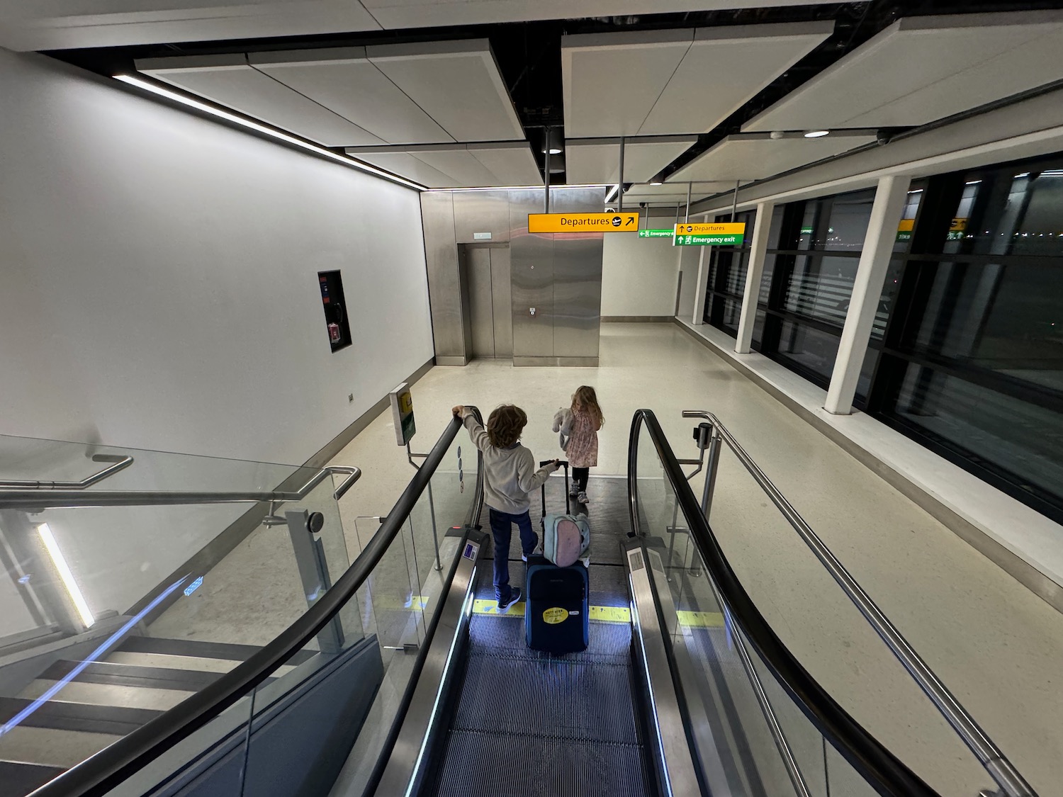two children on an escalator