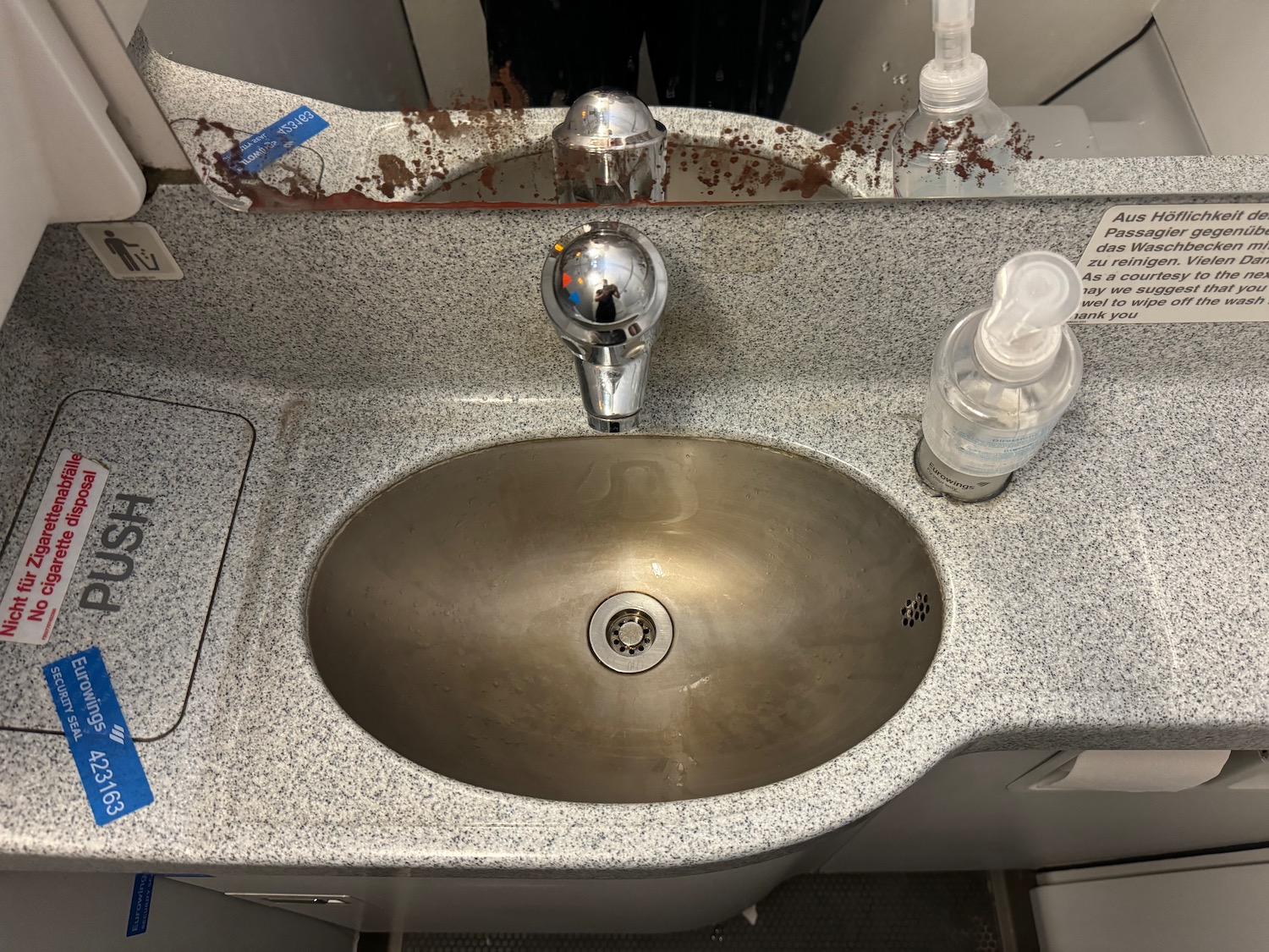 a sink with a faucet and soap dispenser